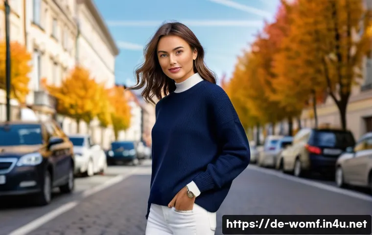 여성용 라운드넥 스웨터 - A stylish young woman wearing a classic crew neck sweater in soft navy blue, paired with fitted jean...